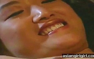 Two sexy Asian lezzies on couch sucking nipples and more