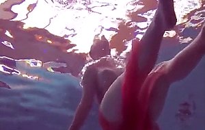 Redhead gapping naked in the pool