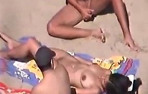 Brunette gets cum on the beach