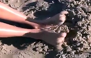 Jessica has sand between her toes