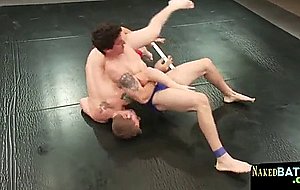 Tattooed muscle hunk wrestles on the floor 