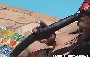 Masked adriana rodrigues strokes her cock poolside