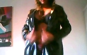 Spanish tgirl poses wearing a latex coat