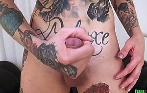 Tattooed up trans chick tugging on her cock  