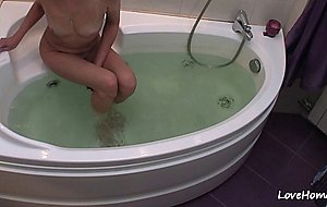 Nerdy blonde gets nude and takes a bath