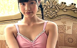 Cute japanese teen in pink leotard with lollipop