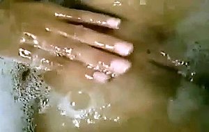 A horny big-tittied chick plays with herself inside the tub