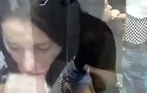 Hot brunette getting her mouth filled with cum in the changing room