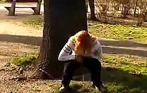 Girl pissing in a public park