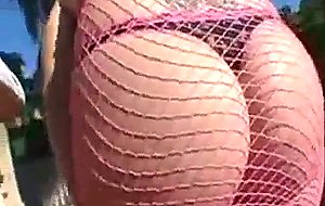 Horny redhead shows off big tits and round ass outdoors