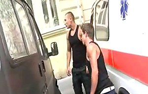 Two guys fuck in  parking lot