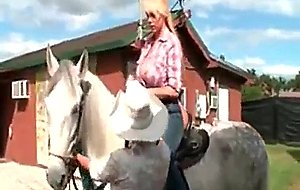 Blonde cowgirl in sweet ass riding a horse