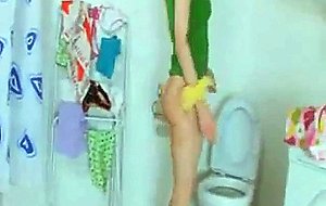 Thin busty girl peeing on a toilet