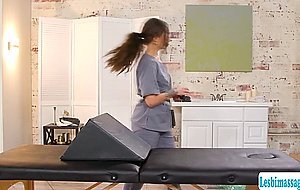 Brunette masseuse gives a finger massage with a bolster