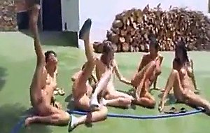 Five naked chicks playing wet game outdoors