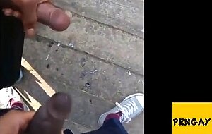 Two men cum together outside