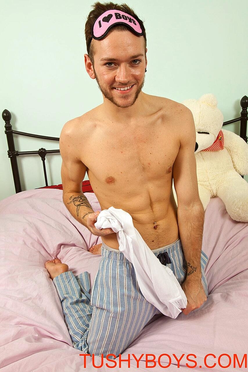 Good-looking gay shows off his big ass in a sexy striptease on his bed