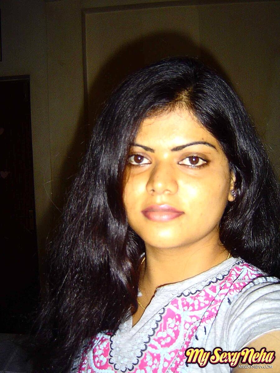 Indian woman Neha takes self shots while she holds her face firm