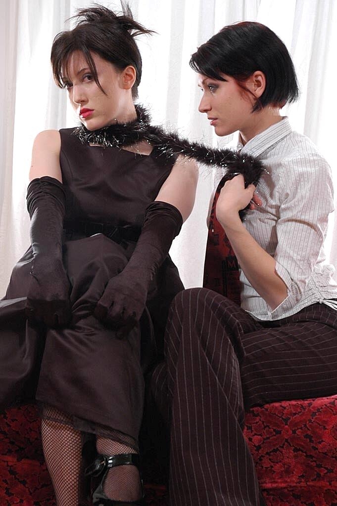 Lesbian girls share a cigarette in a provocative manner during non-nude play