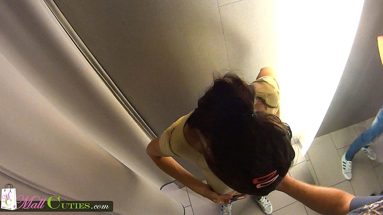 Brunette teen Sandra gives a blowjob in a dressing room at the mall