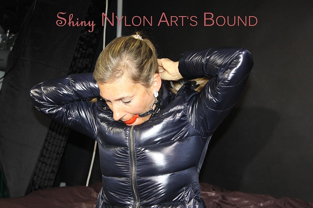 Caucasian chick is gagged and restrained in a winter coat and nylon pants